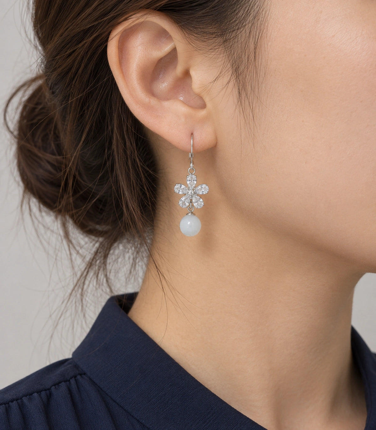JIMIKI Silver Tone Clear Flower White Bead Drop Earring Pair in Silver-tone, model wearing view