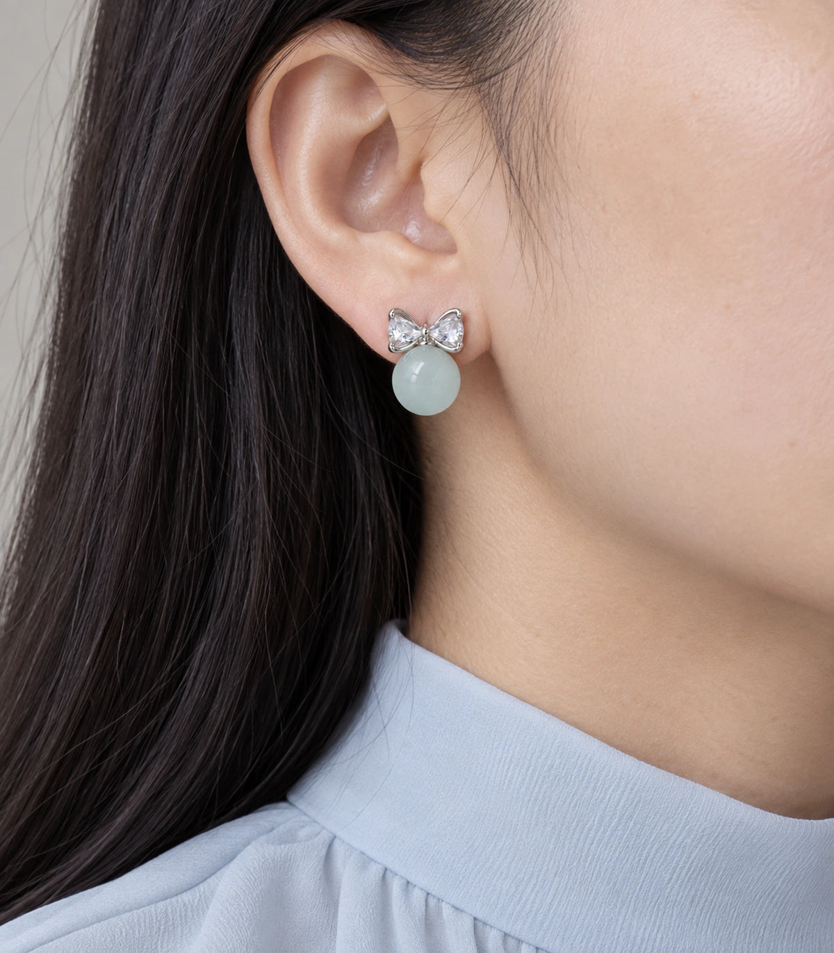 JIMIKI Silver-Tone Crystal Bow Blue Bead Stud Earrings in Silver-tone / pale blue, model wearing view