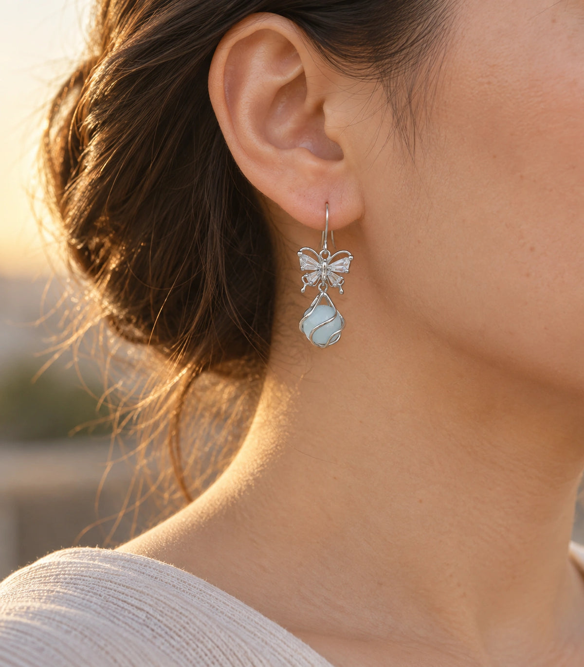 JIMIKI Silver Tone Crystal Butterfly Blue Bead Drop Earring Pair in Silver tone, editorial model view