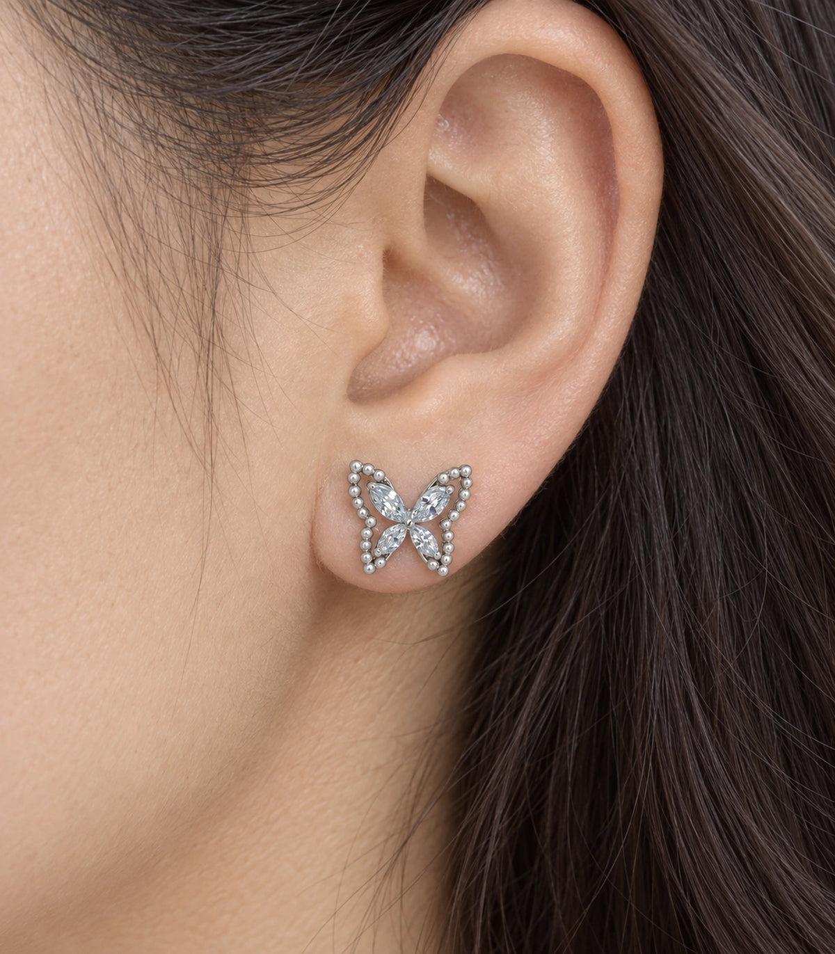 JIMIKI Silver-Tone Crystal Butterfly Stud Earrings in Silver / Clear, close-up detail