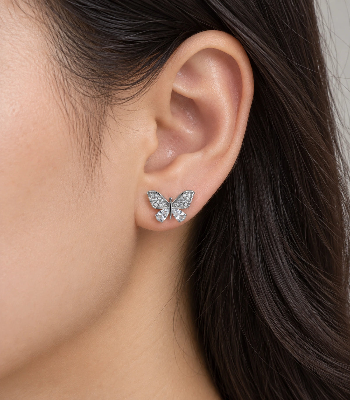 JIMIKI Silver-Tone Crystal Butterfly Stud Earrings in Silver / Clear, close-up detail