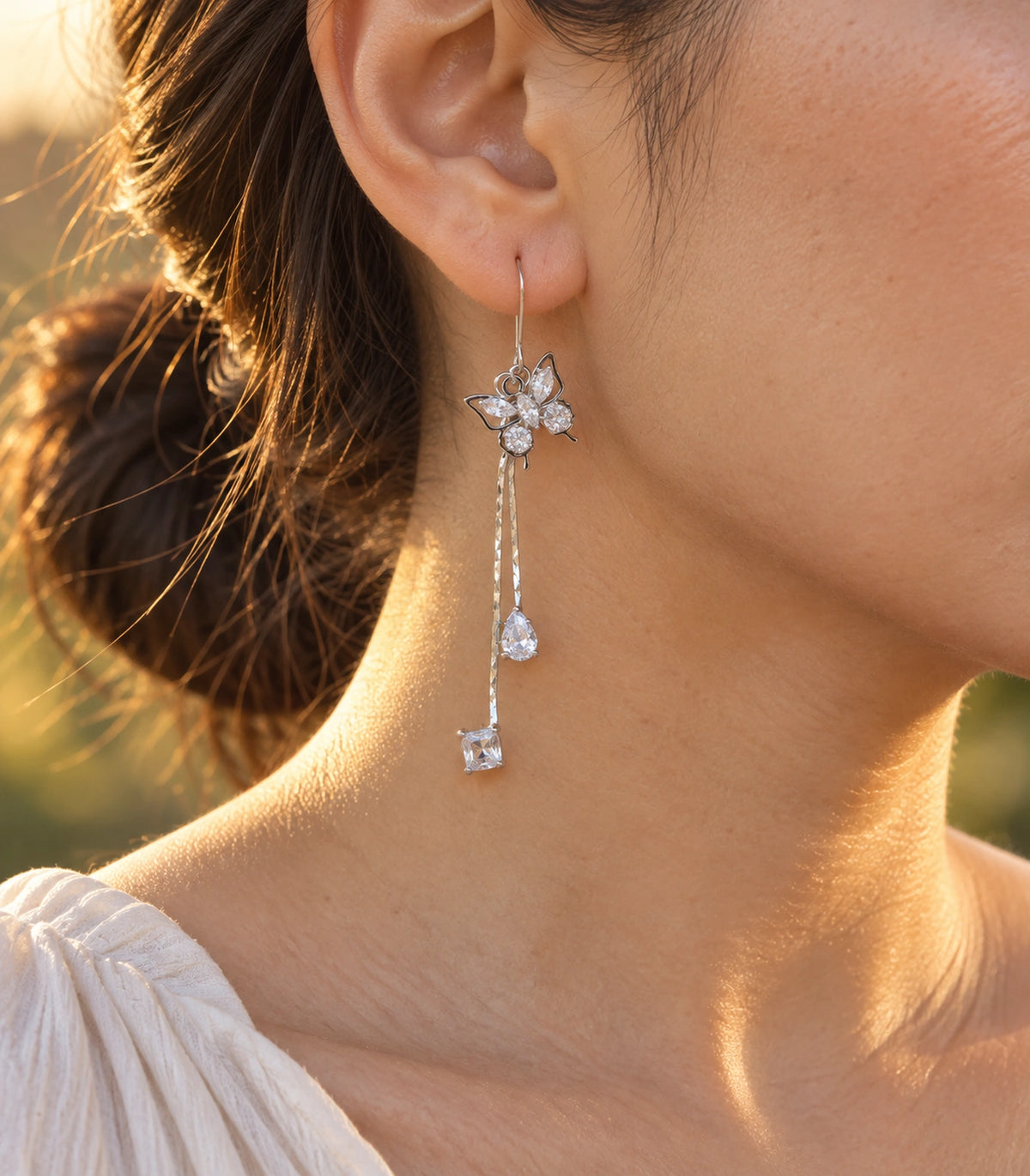 JIMIKI Silver Tone Crystal Butterfly Teardrop Tassel Earring Pair in Silver tone, editorial model view