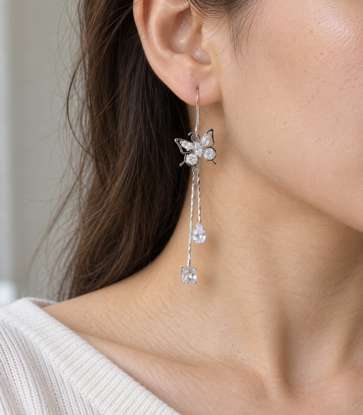 JIMIKI Silver Tone Crystal Butterfly Teardrop Tassel Earring Pair in Silver tone, model wearing view