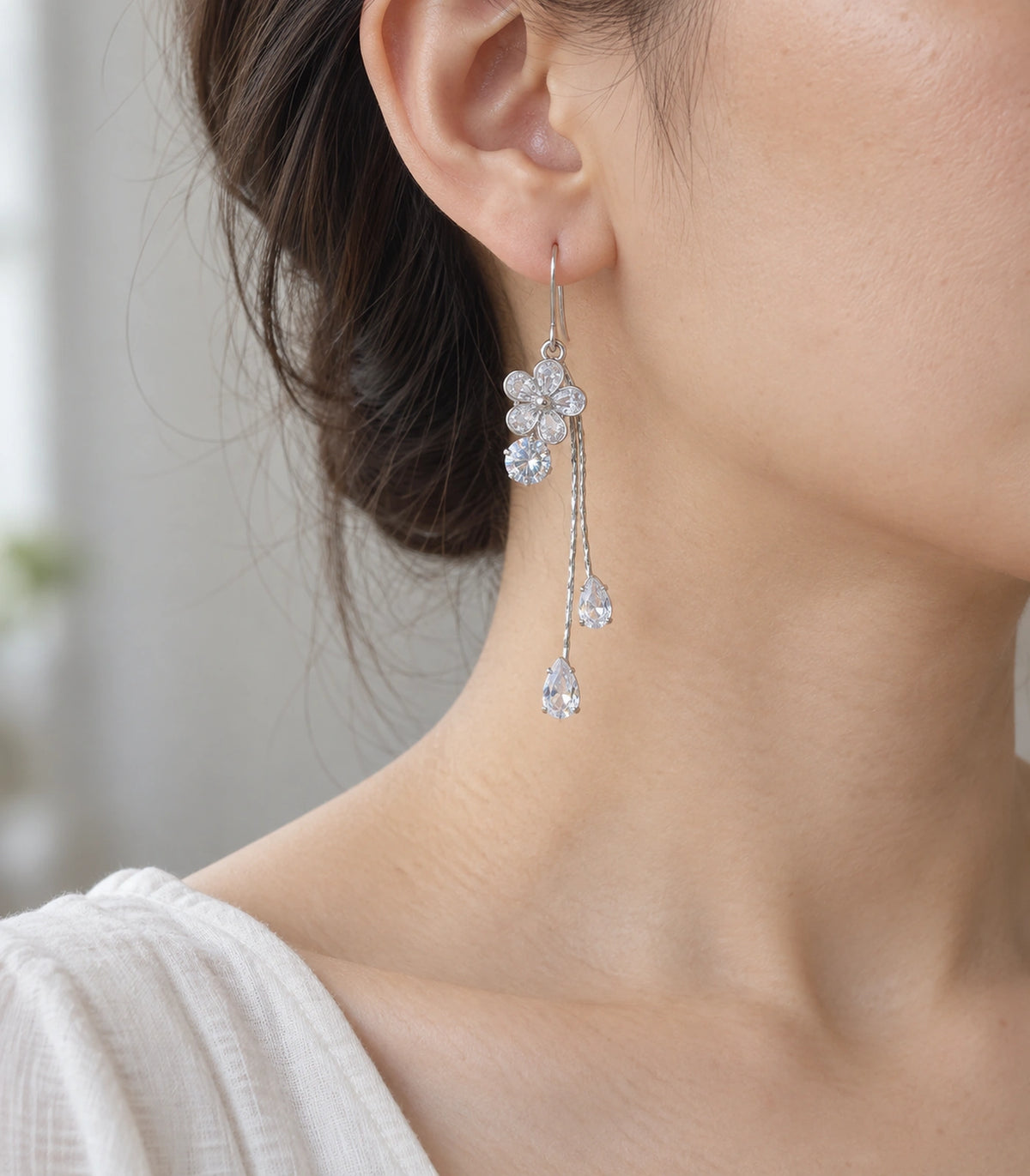 JIMIKI Silver Tone Crystal Flower Teardrop Tassel Earring Pair in Silver tone, model wearing view