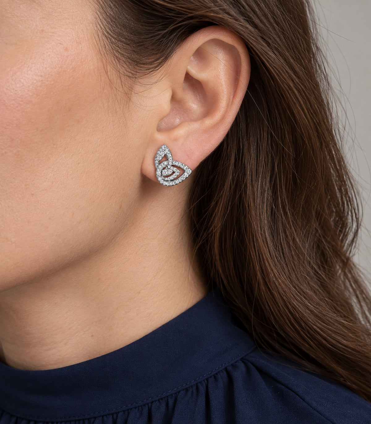 JIMIKI Crystal Open Swirl Stud Earring Pair in Silver tone, model wearing view #color_silver tone