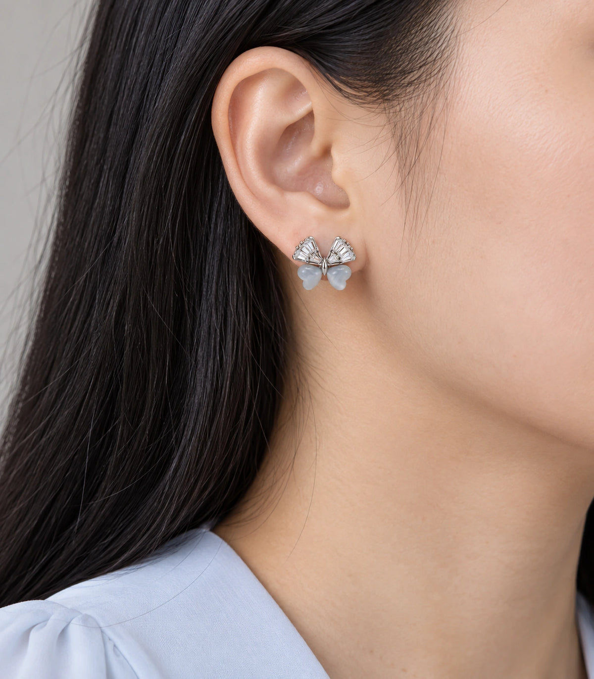 JIMIKI Crystal Wing Butterfly Stud Earring Pair in Silver Tone, model wearing view #color_silver tone