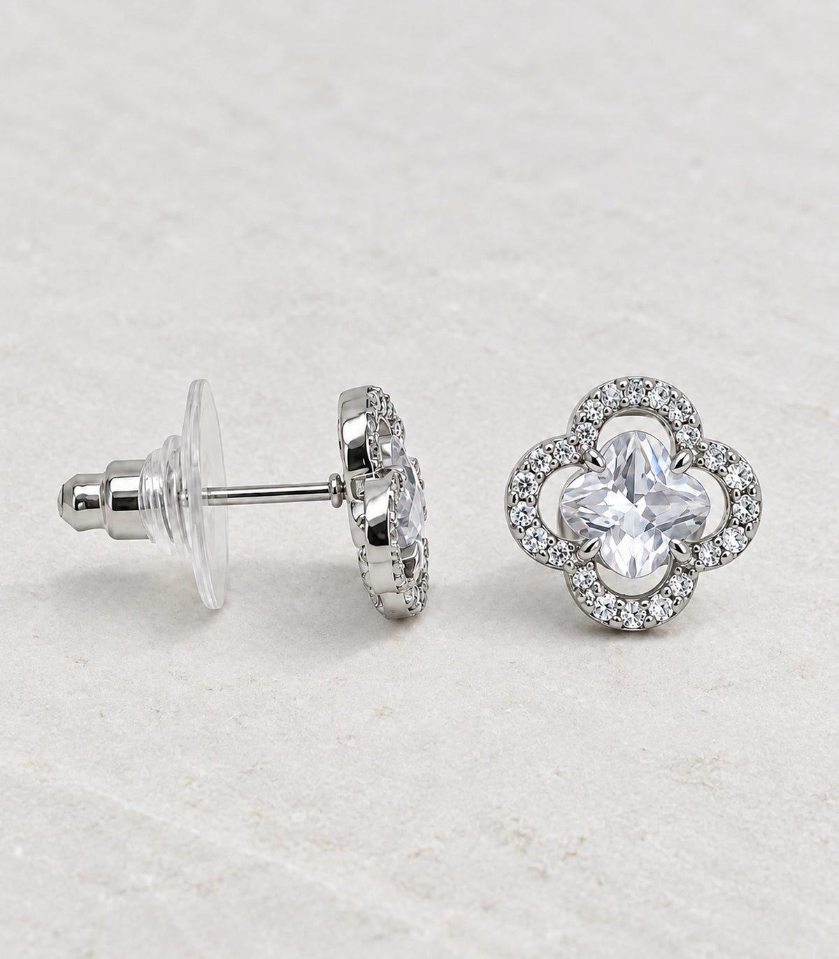 JIMIKI Crystal Quatrefoil Halo Stud Earring Pair in Silver Tone, editorial flat lay #color_silver tone