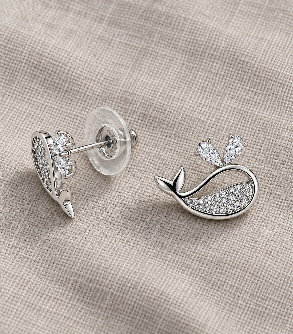 JIMIKI Crystal Whale Stud Earring Pair in Silver-tone, editorial flat lay #color_silver-tone
