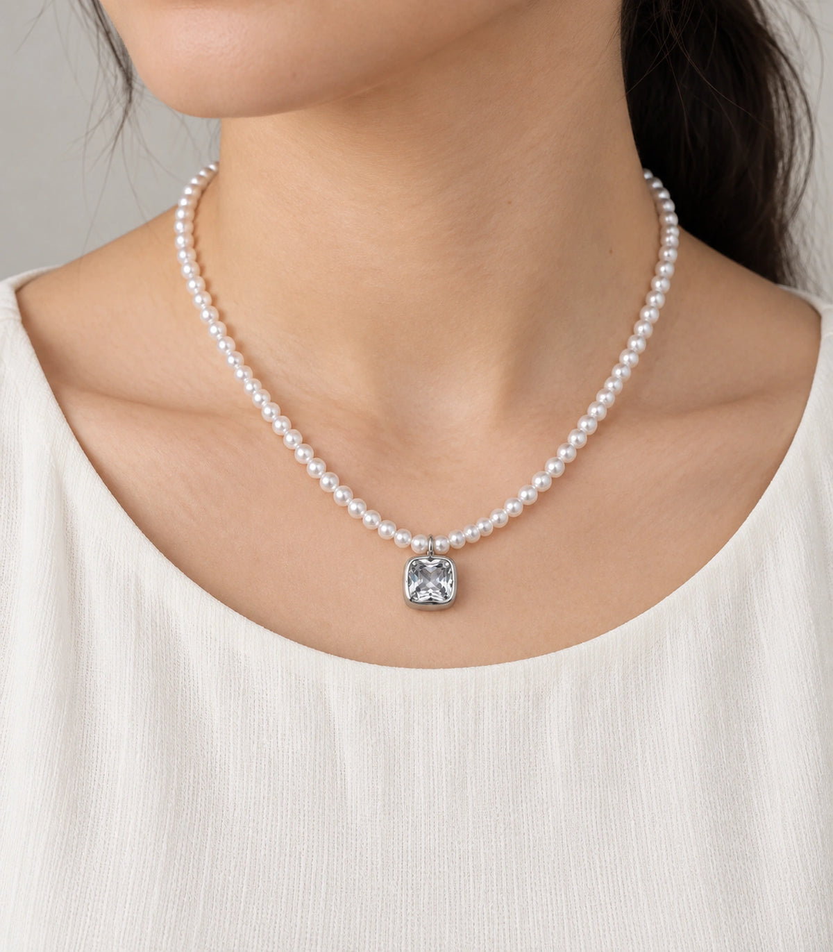 JIMIKI Silver Tone Cushion Crystal Pearl Style Necklace in Silver tone / white, model wearing view