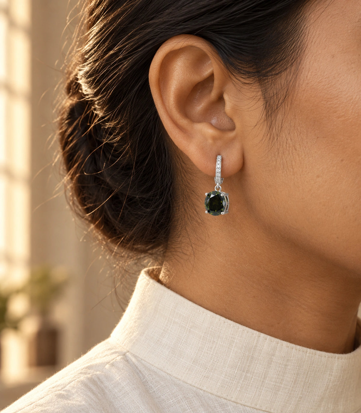 JIMIKI Round Crystal Hoop Drop Earring Pair in Silver tone / dark green, editorial model view #color_silver tone / dark green