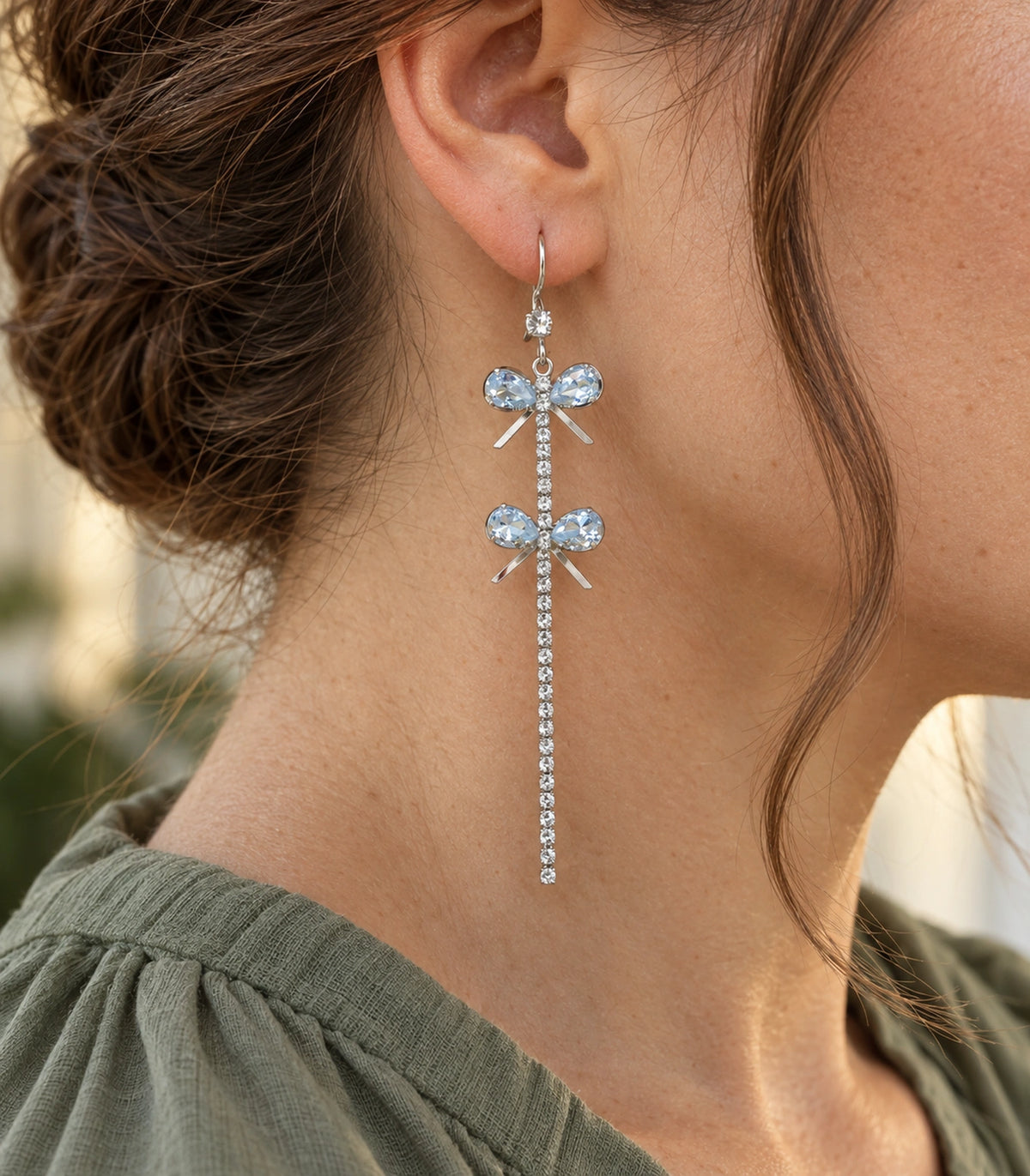 JIMIKI Silver Tone Double Crystal Bow Tassel Earring Pair in Silver-tone, editorial model view
