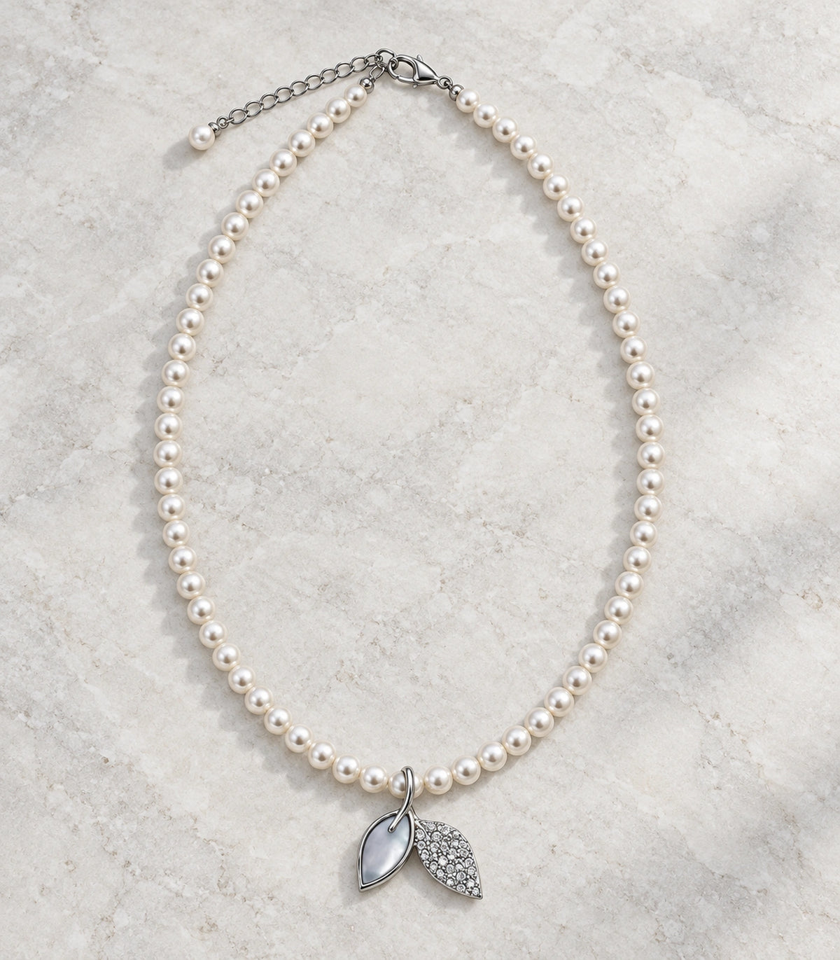 JIMIKI Silver Tone Double Leaf Pearl Style Necklace in Silver tone / white, editorial flat lay