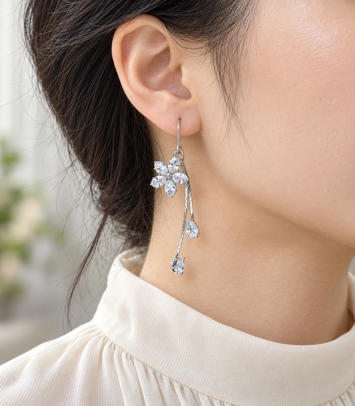 JIMIKI Silver-Tone Five-Petal Crystal Flower Twin Pear Drop Earrings in Silver Tone, model wearing view