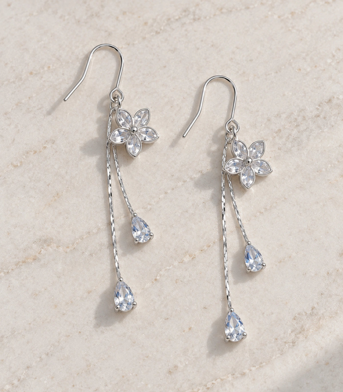 JIMIKI Silver Tone Five Petal Flower Twin Pear Drop Earring Pair in Silver-tone, editorial flat lay