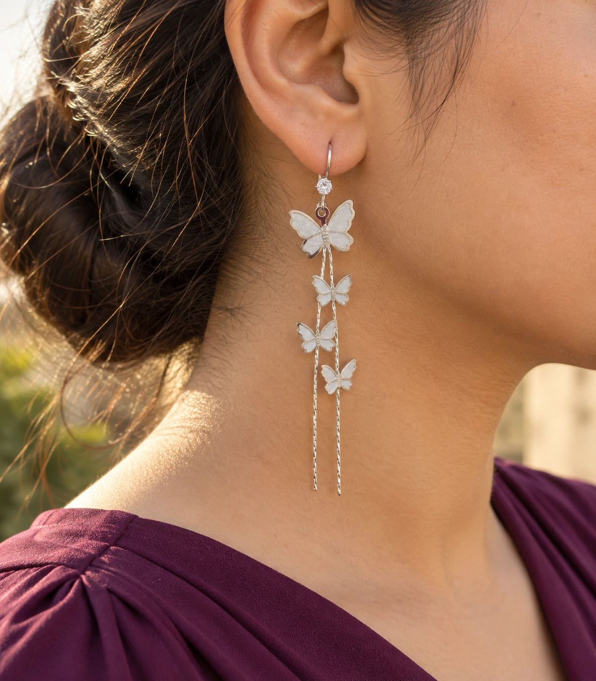 JIMIKI Silver Tone Four Butterfly Chain Earring Pair in Silver-tone, editorial model view