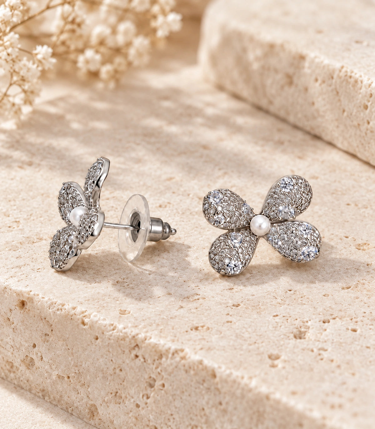 JIMIKI Four Petal Pave Pearl Centre Stud Earring Pair in Silver tone, editorial flat lay #color_silver tone
