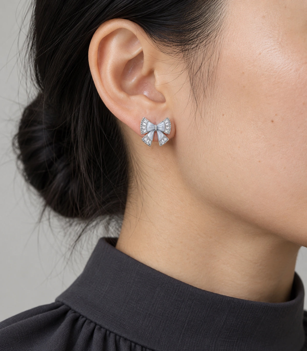 JIMIKI Silver Tone Grey Bow Clear Crystal Stud Earring Pair in Silver tone, model wearing view