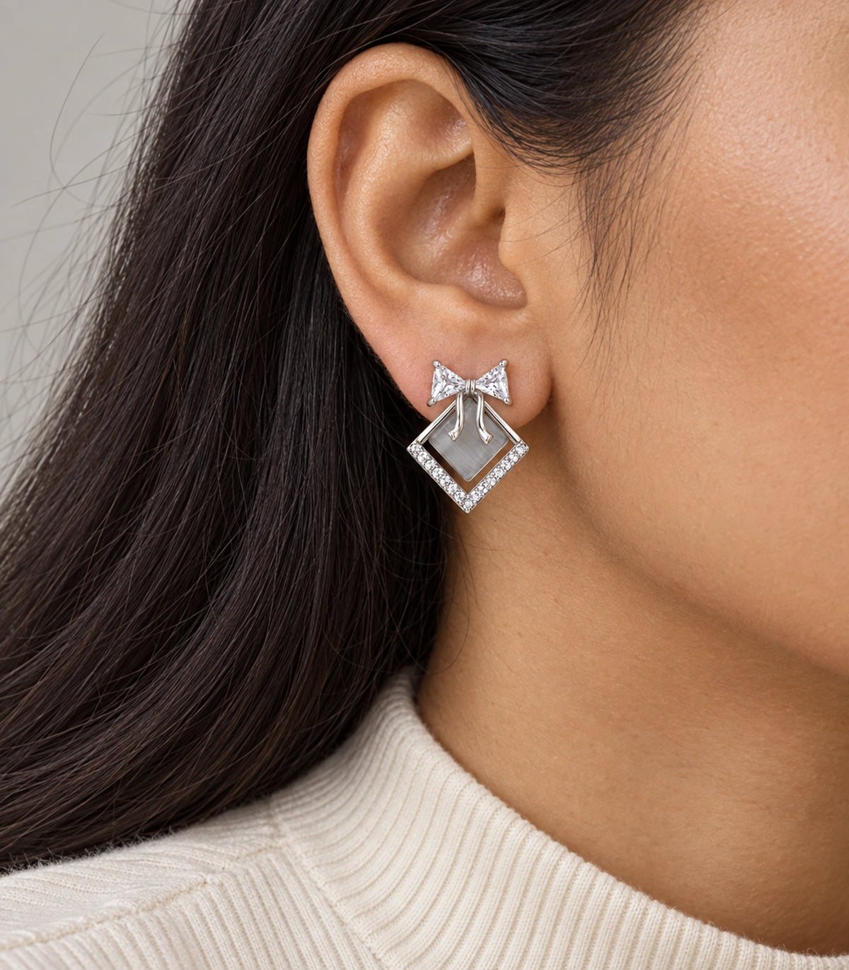 JIMIKI Silver Tone Grey Diamond-Shaped Bow Crystal Stud Earring Pair in Silver tone, model wearing view