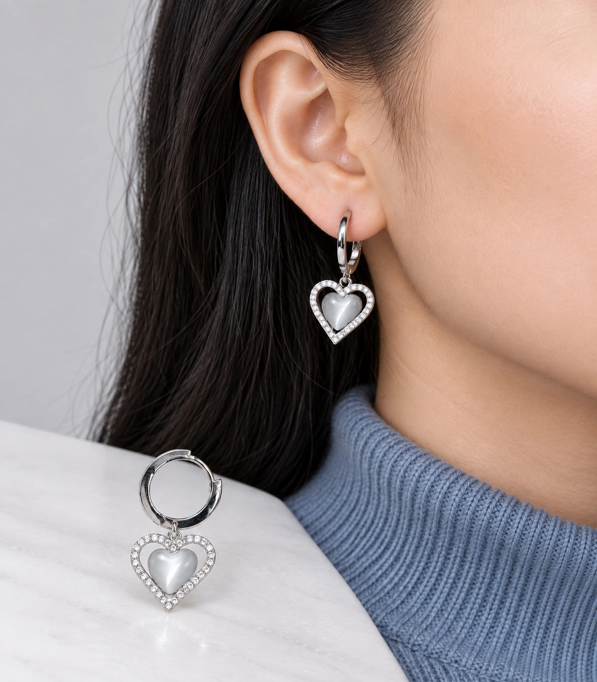JIMIKI Heart Crystal Frame Drop Hoop Earring Pair in Silver-tone / Grey, model wearing view #color_silver-tone / grey