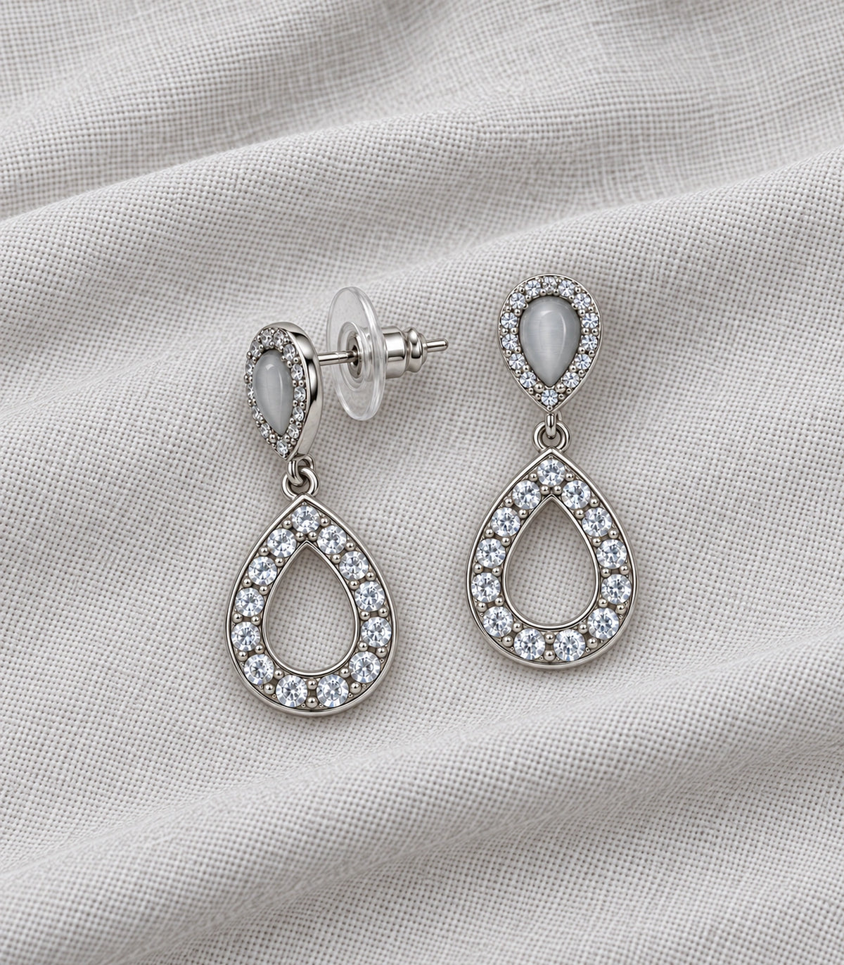 JIMIKI Silver-Tone Grey Teardrop Crystal Halo Drop Earring Pair in Silver Tone, editorial flat lay