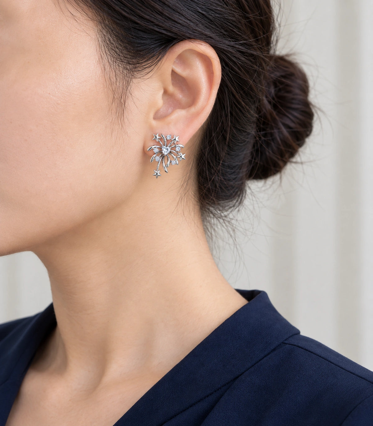 JIMIKI Heart Crystal Starburst Stud Earring Pair in Silver tone/Clear, model wearing view #color_silver tone/clear