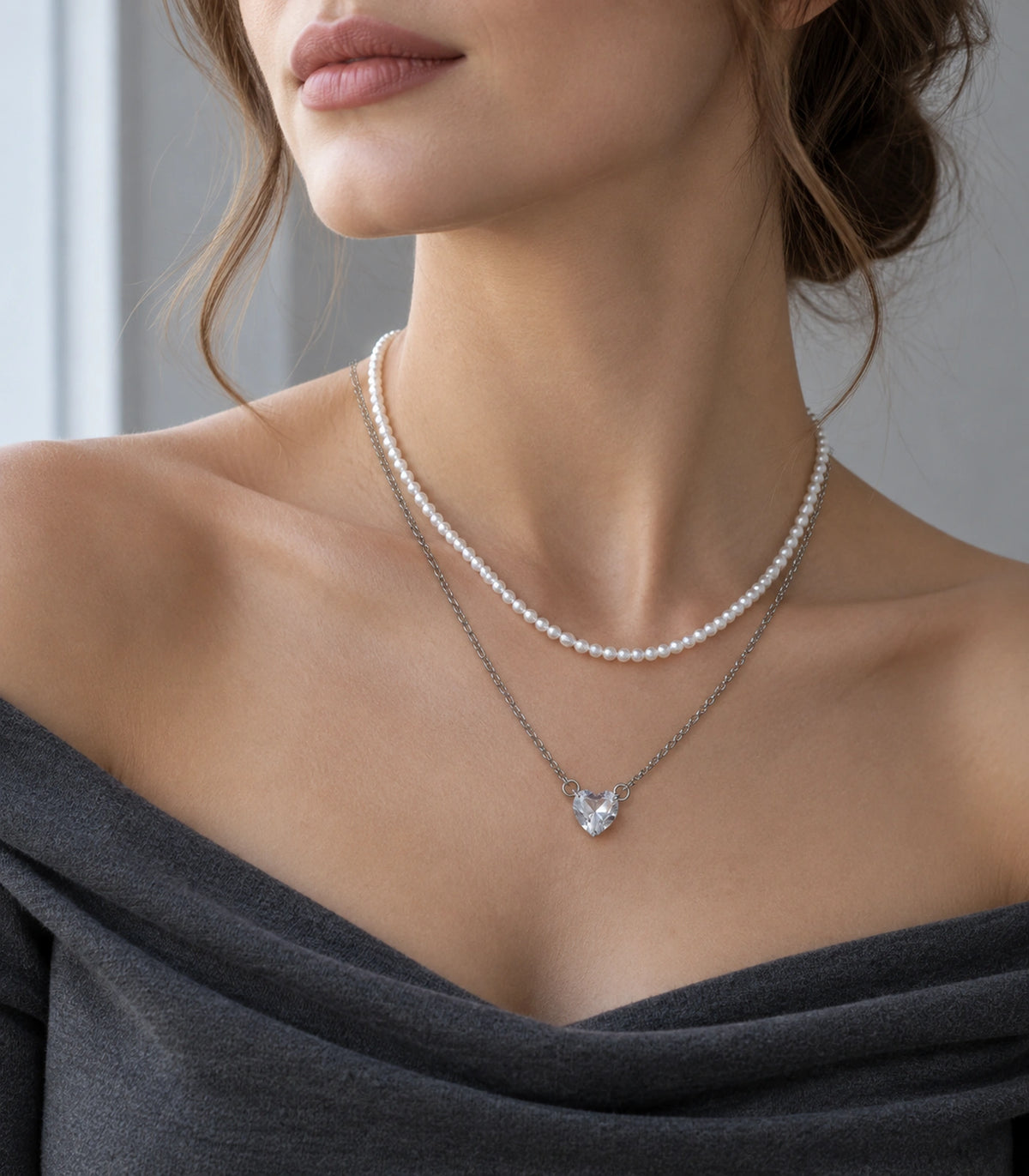 JIMIKI Silver-Tone Heart Layered Pearl Necklace Set in Silver-tone / clear / white, styled on a model in an editorial setting