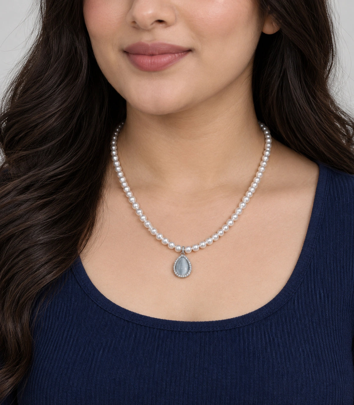 JIMIKI Silver-Tone Icy Blue Teardrop Pearl Necklace in Silver-tone / icy blue, worn with a simple outfit