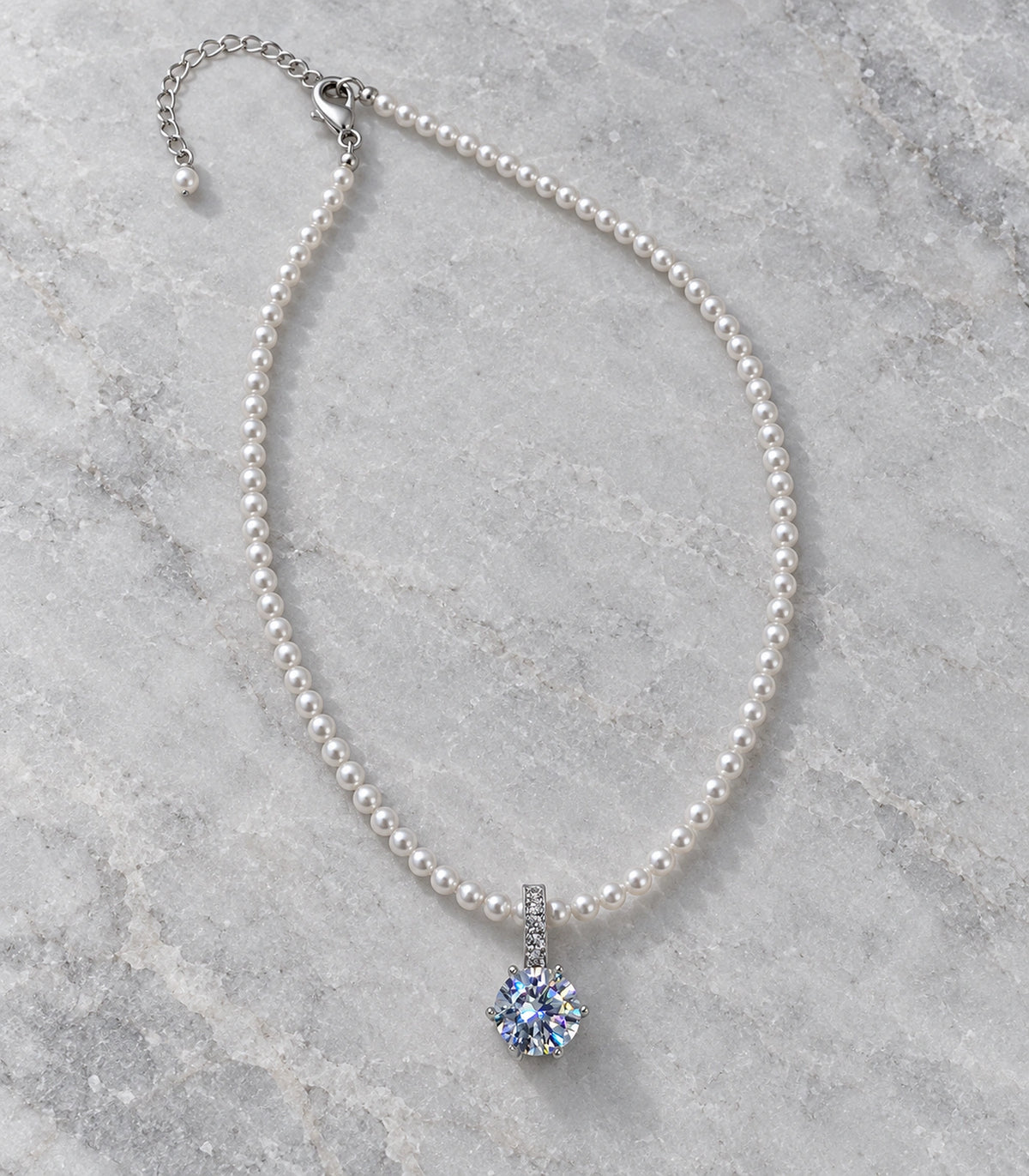 JIMIKI Silver Tone Iridescent Round Crystal Pearl Style Necklace in Silver tone / white / iridescent crystal, editorial flat lay
