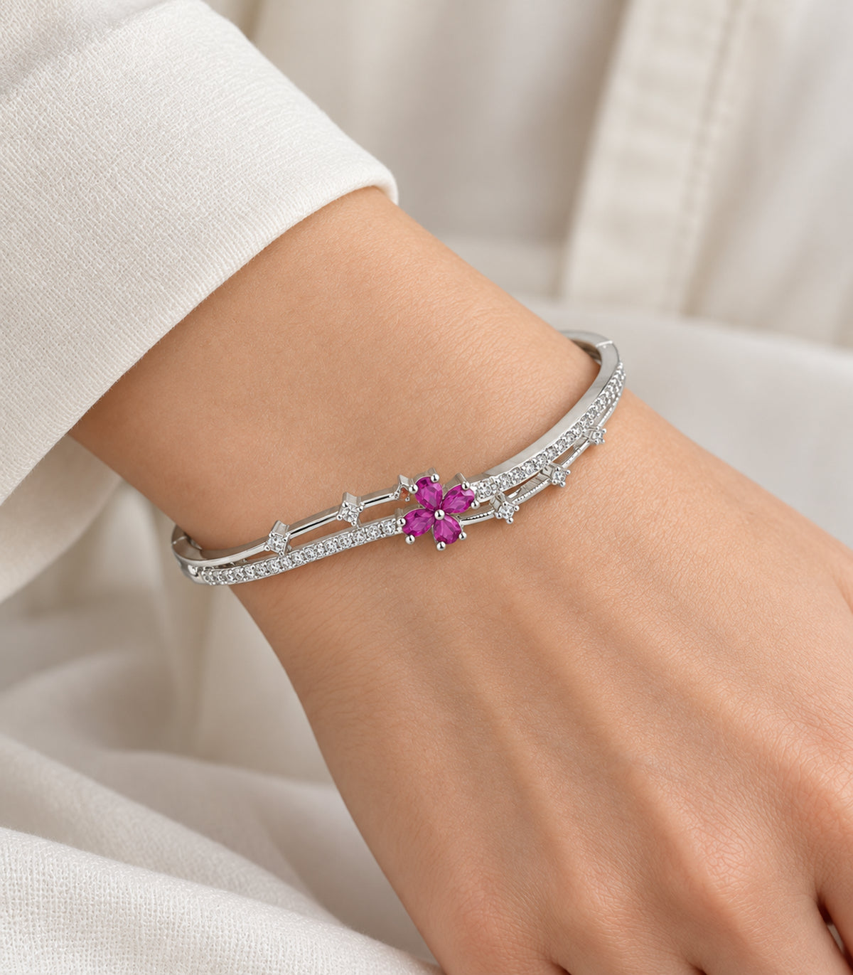 Silver-tone magenta flower and clear bar bangle — closeup view; one bangle