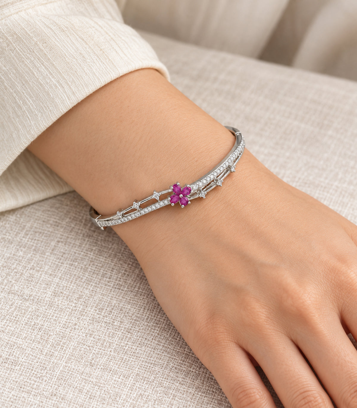 Silver-tone magenta flower and clear bar bangle — model view; one bangle