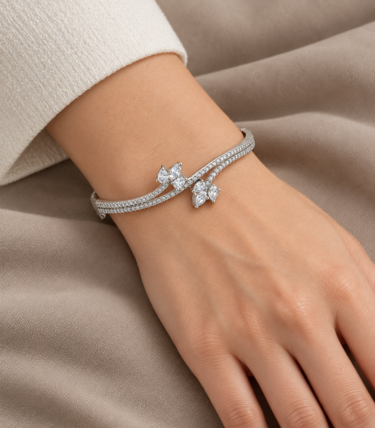 Silver-tone marquise cluster crossover bangle, closeup view