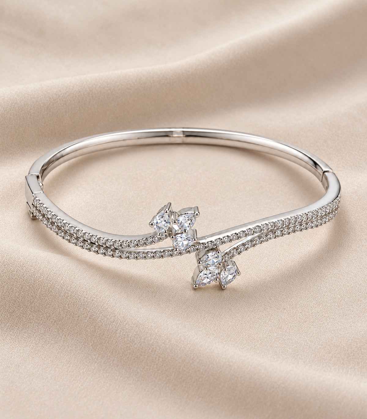 Silver-tone marquise cluster crossover bangle, editorial flatlay view