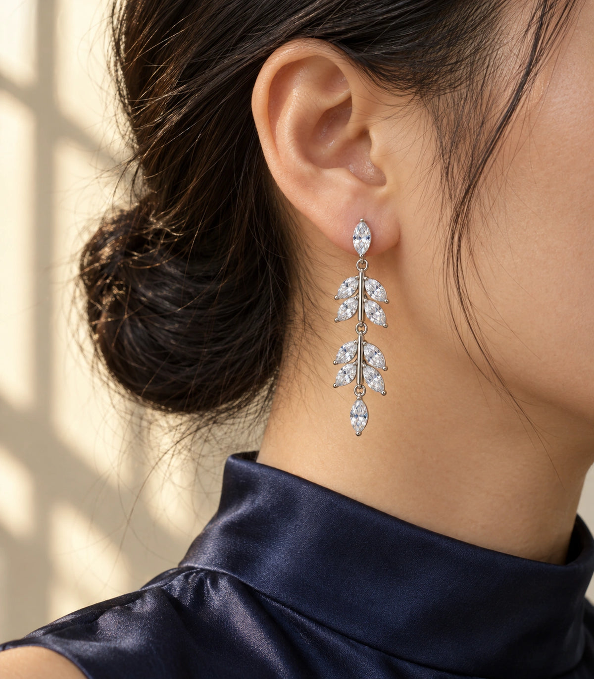 JIMIKI Marquise Crystal Leaf Drop Earring Pair in Silver tone, editorial model view #color_silver tone