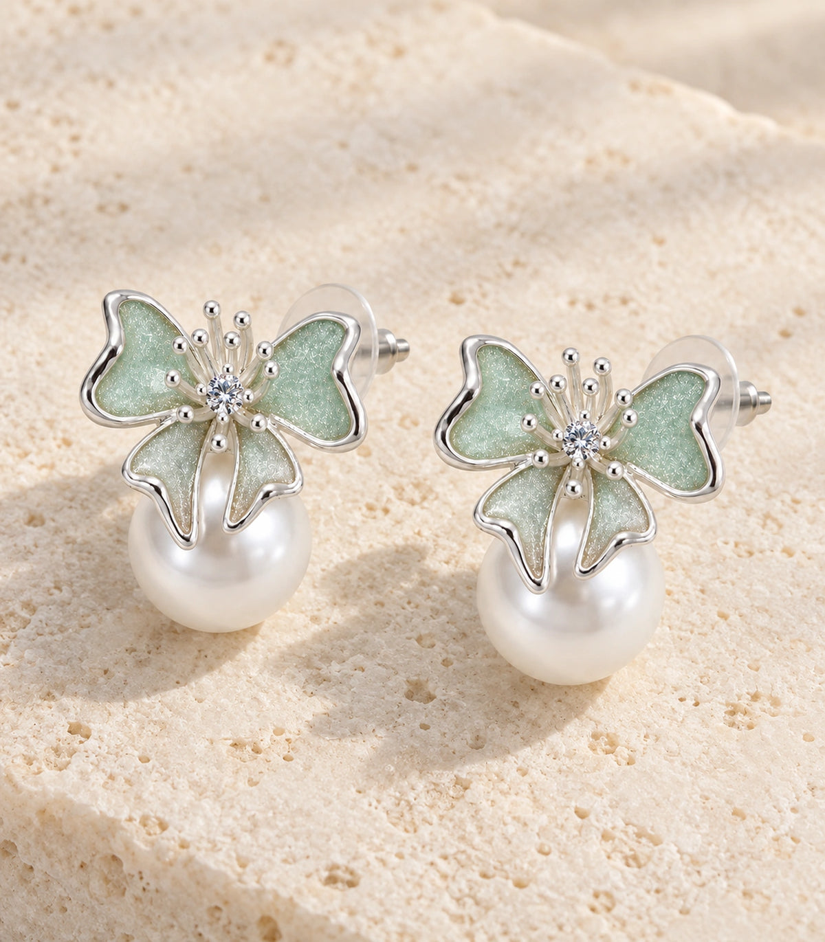 JIMIKI Butterfly Pearl Stud Earring Pair in Silver Tone / Mint, editorial flat lay #color_silver tone / mint