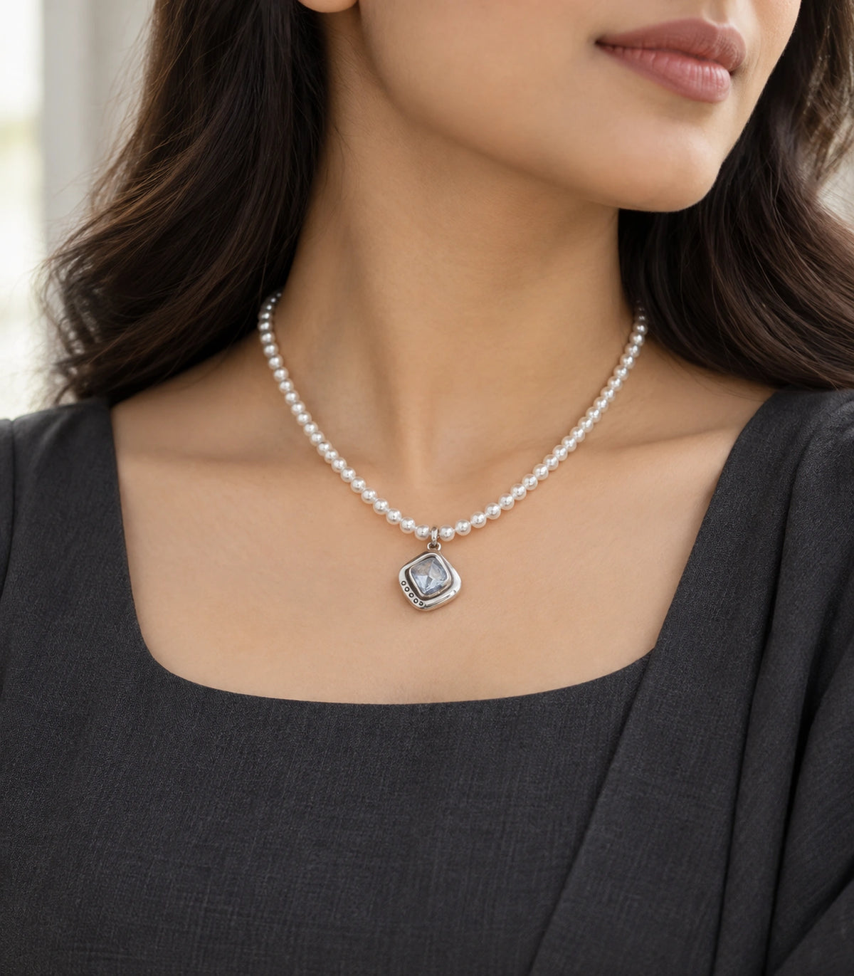 JIMIKI Silver-Tone Organic Cushion Crystal Pearl Necklace in Silver-tone / clear / white, styled on a model in an editorial setting