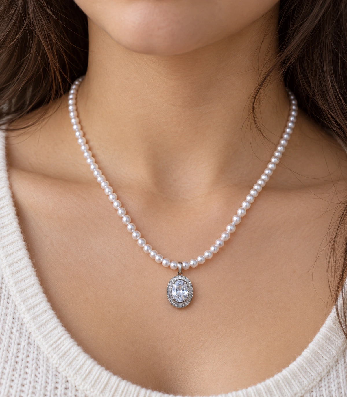 JIMIKI Silver-Tone Oval Baguette Halo Pearl Necklace in Silver-tone / clear / white, close-up of the pendant and pearl-style strand