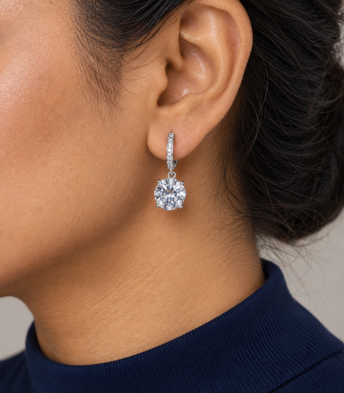 JIMIKI Silver-Tone Oversized Round Solitaire Drop Huggie Earrings in Silver / Clear, model wearing view