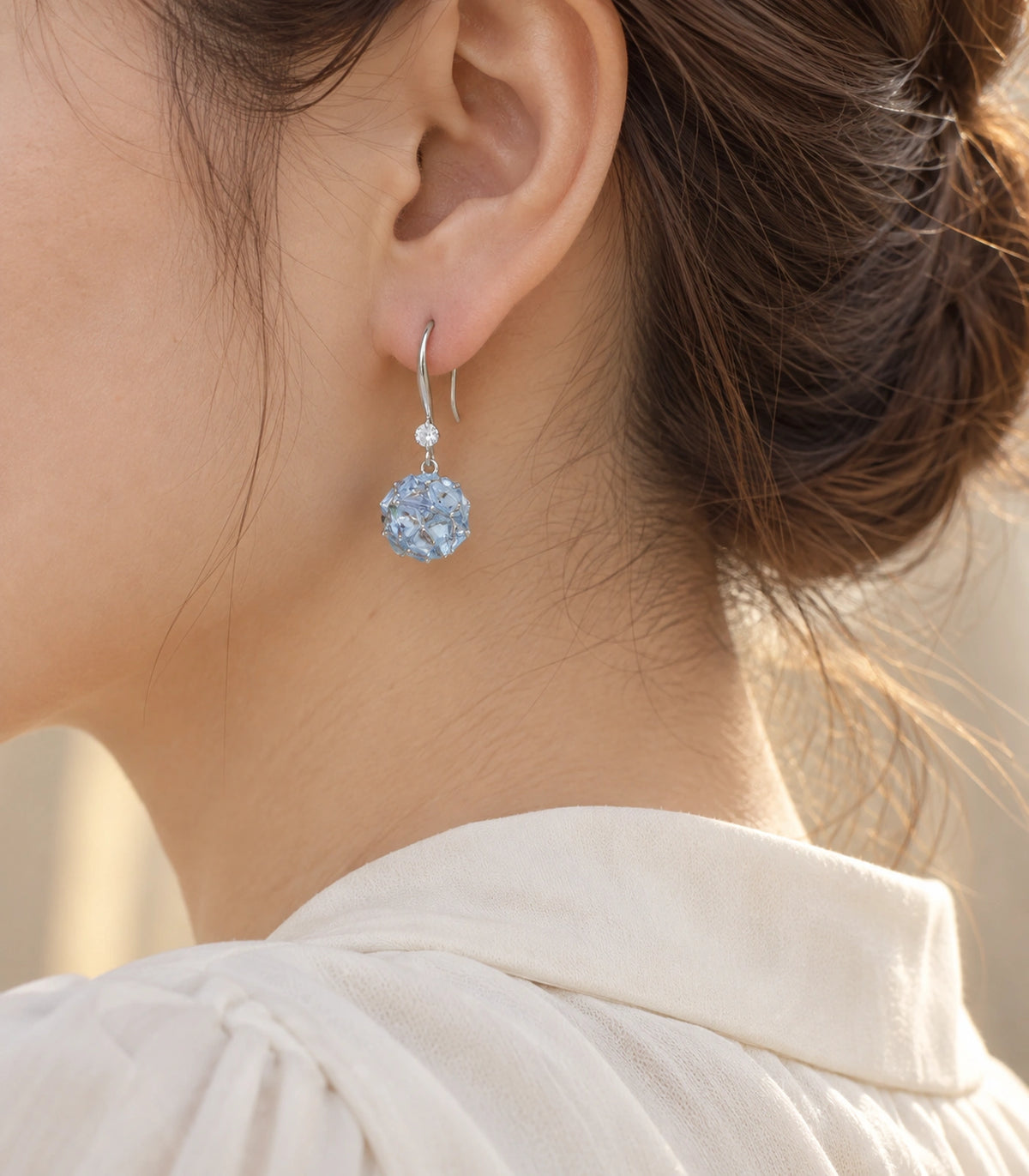 JIMIKI Silver Tone Pale Blue Crystal Ball Drop Earring Pair in Silver-tone, editorial model view
