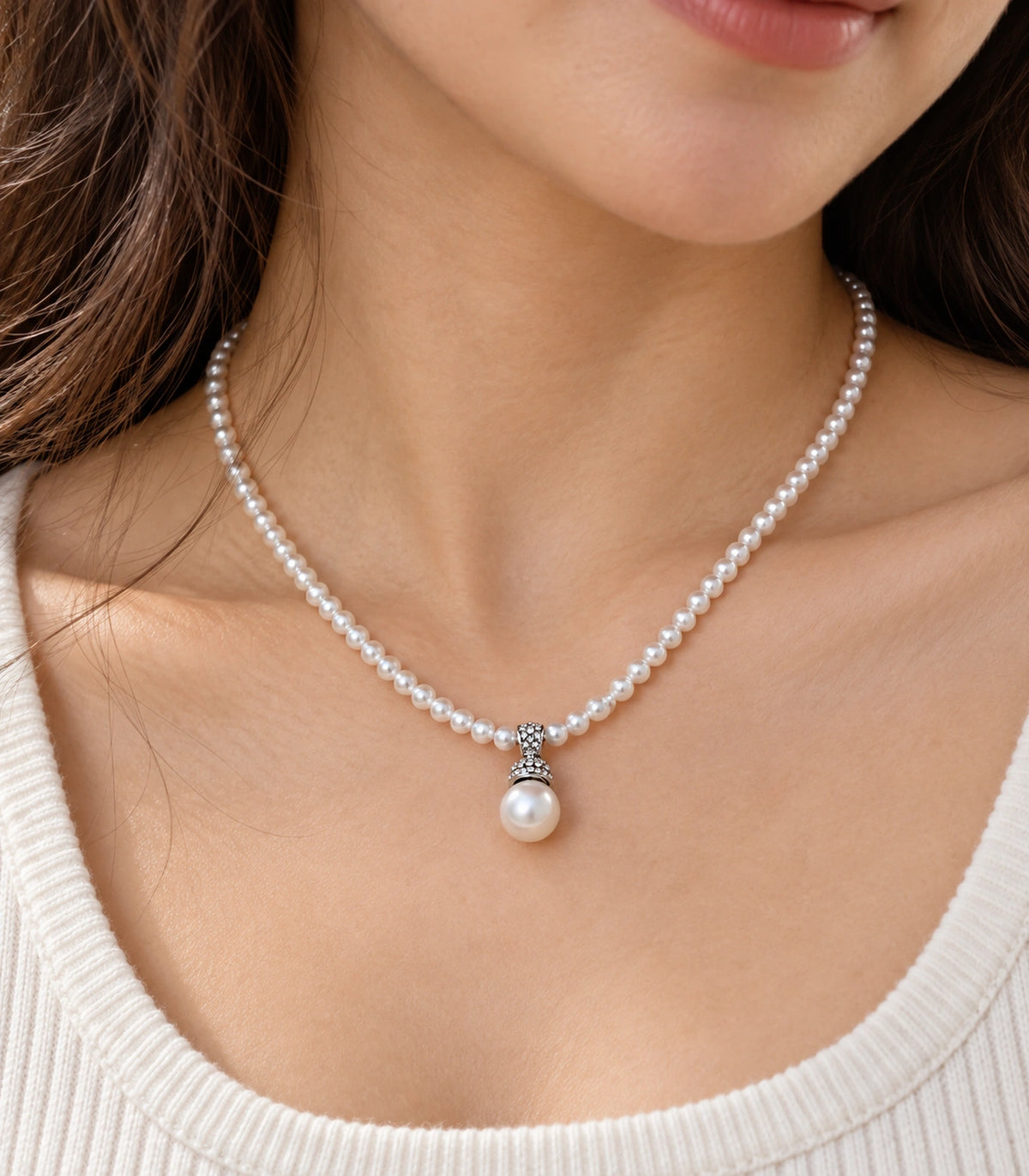 JIMIKI Silver-Tone Pavé Cap Pearl Drop Necklace in Silver-tone / clear / white, close-up of the pendant and pearl-style strand
