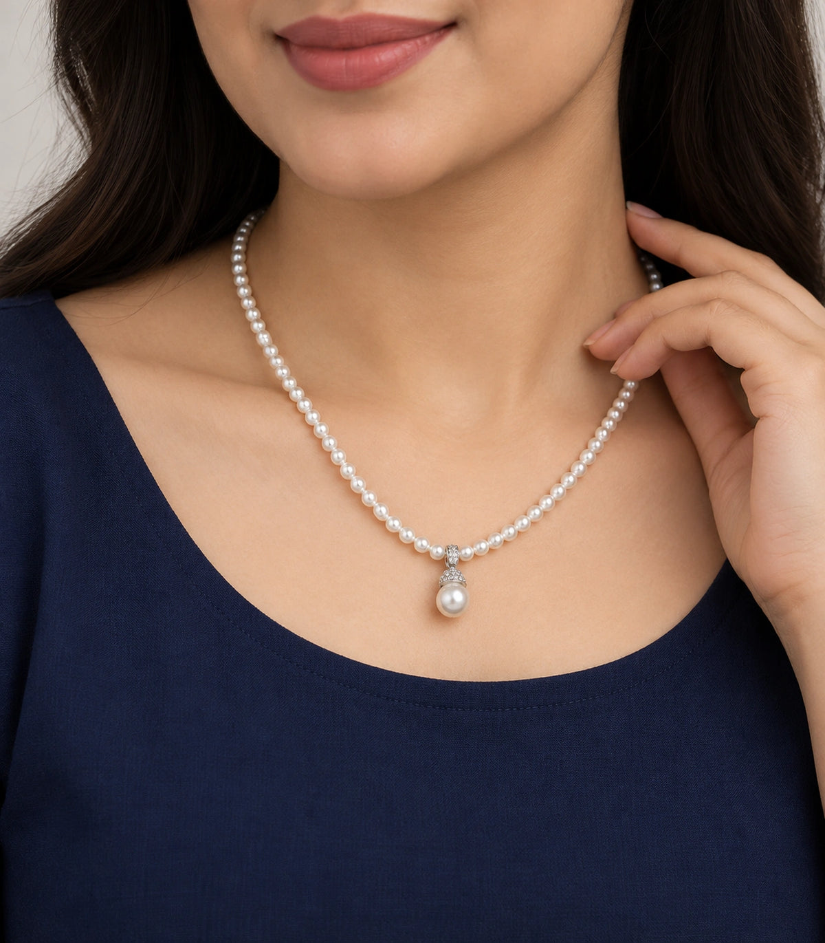 JIMIKI Silver-Tone Pavé Cap Pearl Drop Necklace in Silver-tone / clear / white, worn with a simple outfit