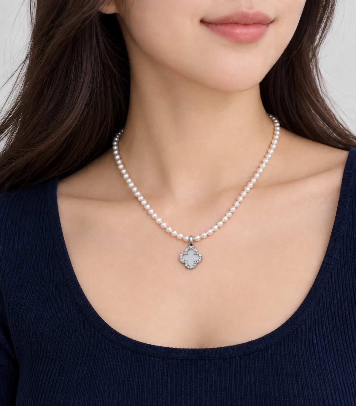 JIMIKI Silver-Tone Pavé Clover Pearl Necklace in Silver-tone / clear / white, worn with a simple outfit