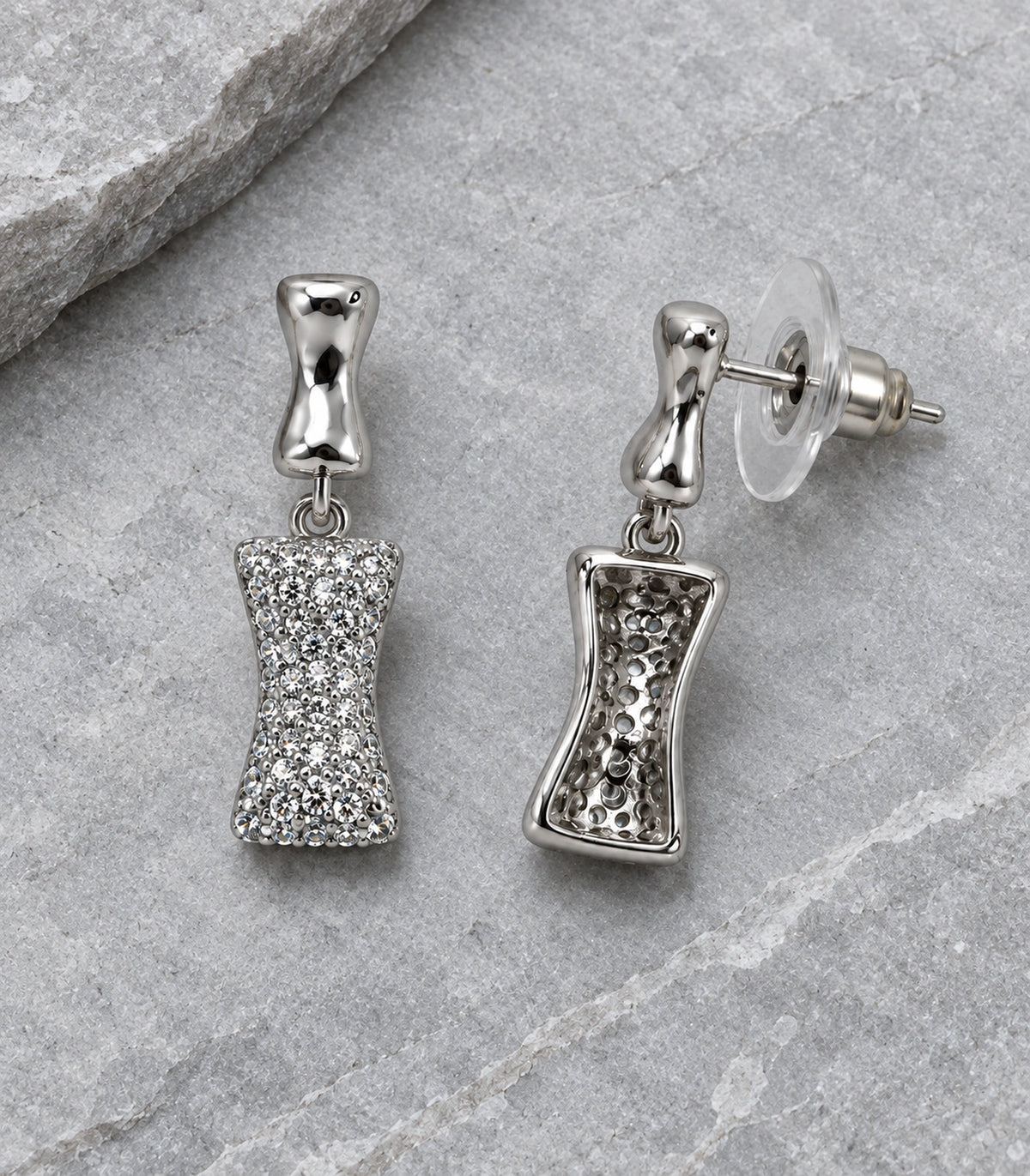 JIMIKI Pave Hourglass Drop Earring Pair in Silver tone, editorial flat lay #color_silver tone