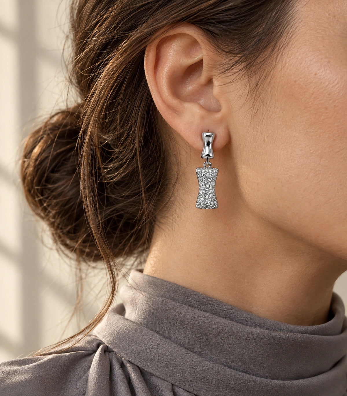 JIMIKI Pave Hourglass Drop Earring Pair in Silver tone, editorial model view #color_silver tone