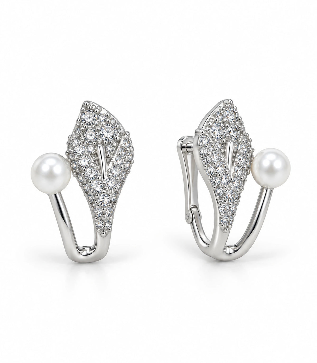 Silver-tone pavé leaf and white pearl-style ear jacket earrings, matching pair on white background