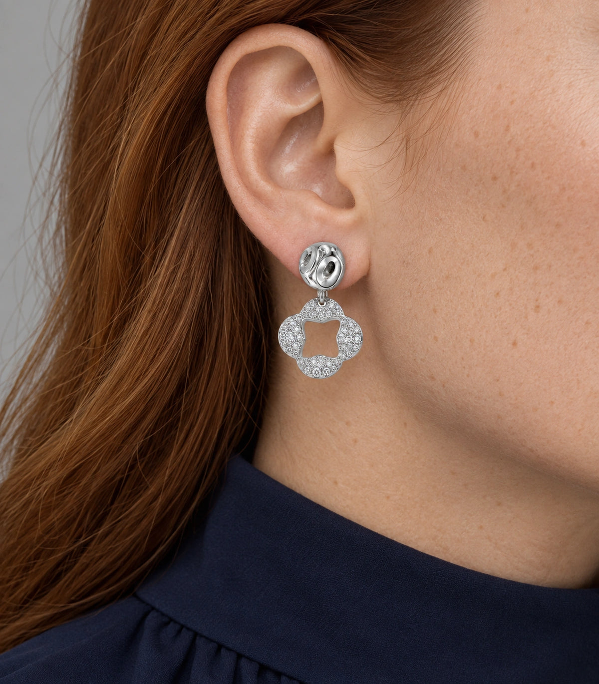 JIMIKI Silver Tone Pave Open Flower Sculpted Stud Drop Earring Pair in Silver tone / clear, model wearing view