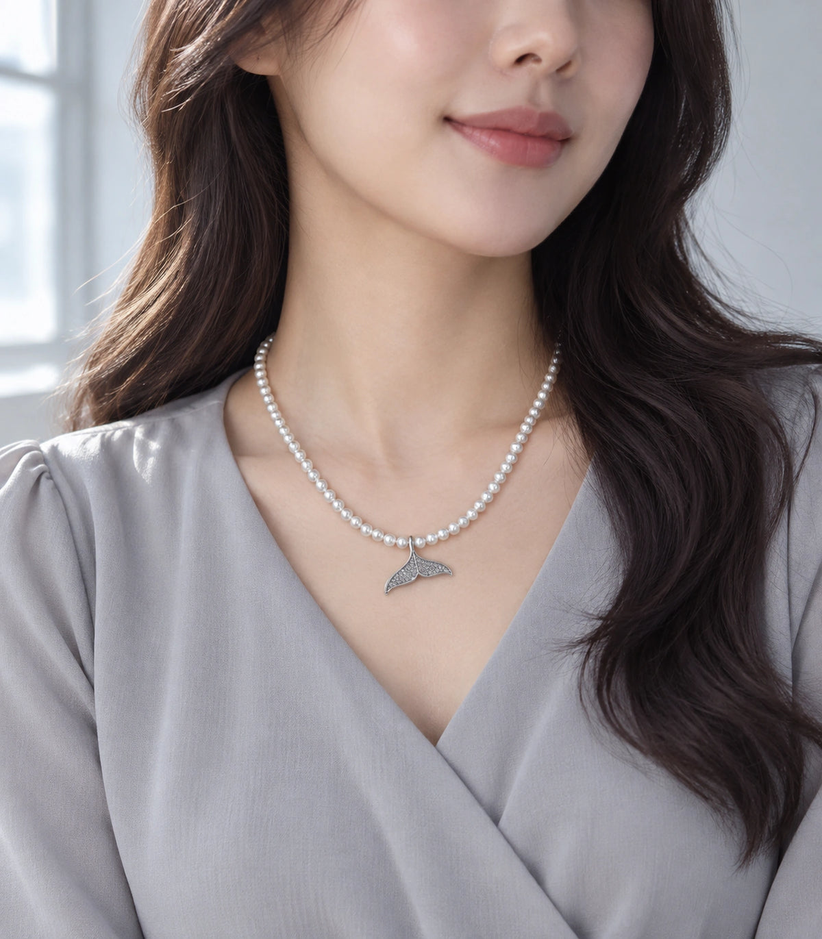 JIMIKI Pavé Whale Tail Pearl Necklace in Silver-tone, styled on a model in an editorial setting #color_silver-tone