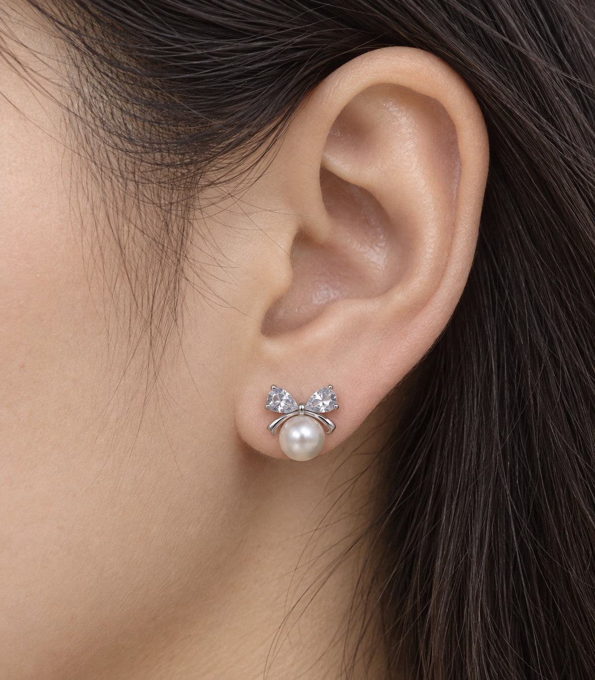 JIMIKI Silver-Tone Pearl Crystal Bow Stud Earrings in Silver / White, close-up detail