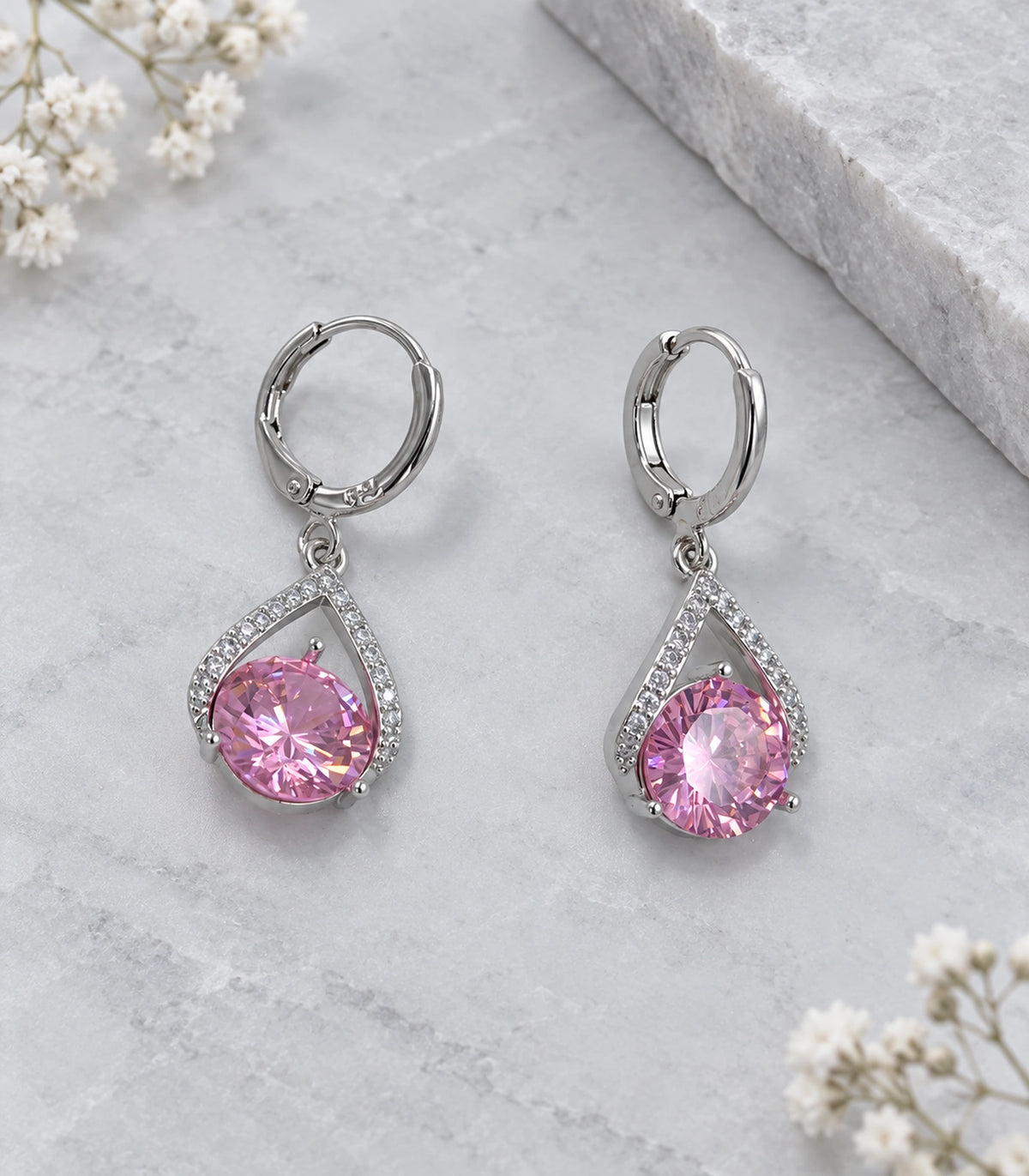 JIMIKI Silver-Tone Pink Crystal Teardrop Huggie Earrings in Silver / Pink, editorial flat lay