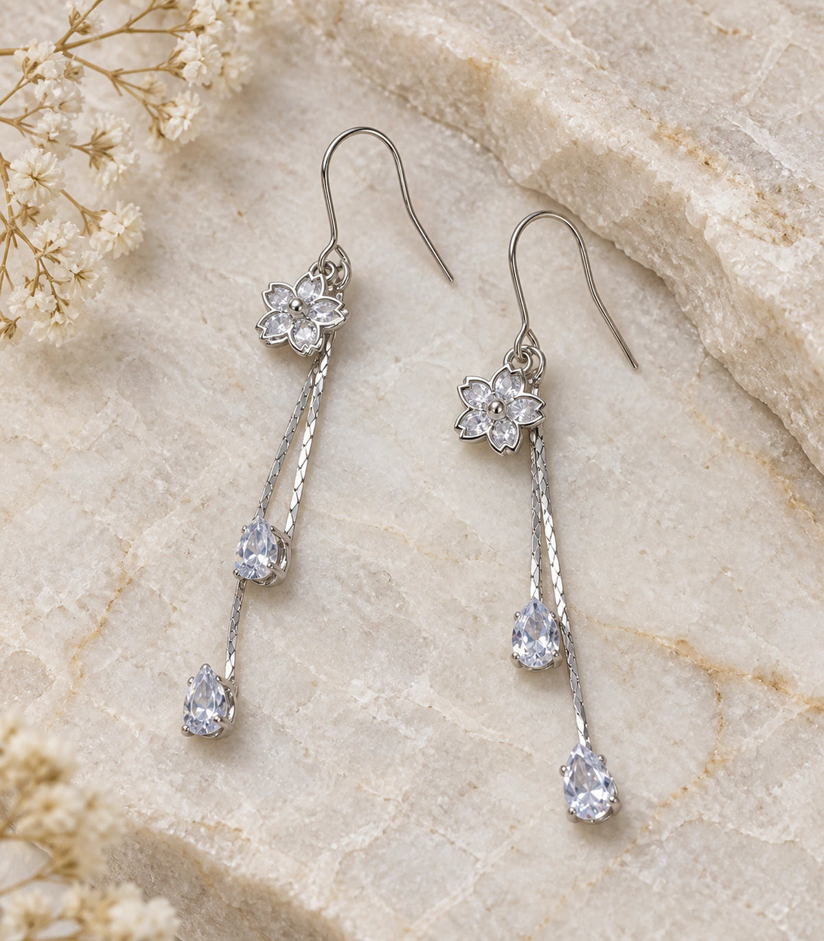 JIMIKI Silver Tone Pointed Flower Twin Pear Chain Earring Pair in Silver-tone, editorial flat lay