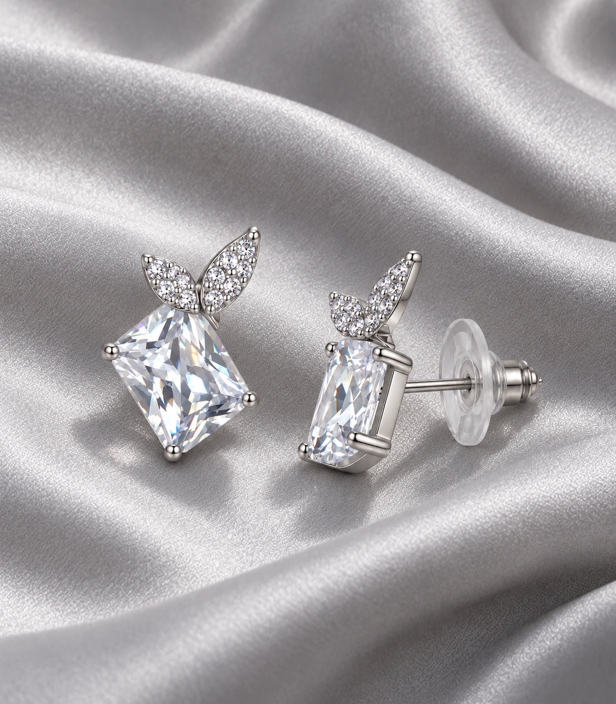 JIMIKI Rectangular Crystal Twin Leaf Stud Earring Pair in Silver-tone, editorial flat lay #color_silver-tone